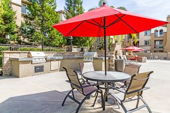 Multiple bbq's surrounded by granite counters and a massive fireplace to gather around